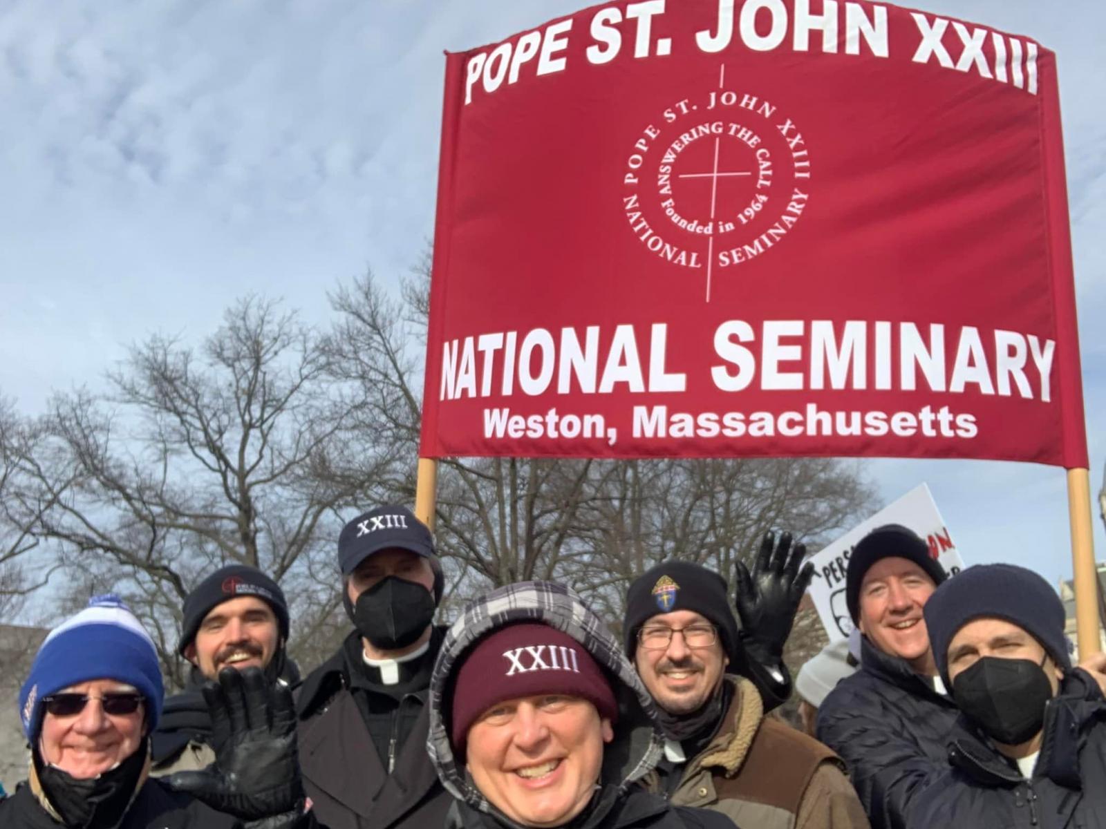 Seminarians marching with sign.jpg